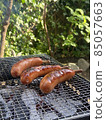 Sausages baked on a sunny day barbecue 85057663