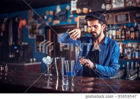 Bartender makes a cocktail on the bar Bartender makes a cocktail on the bar 85059547