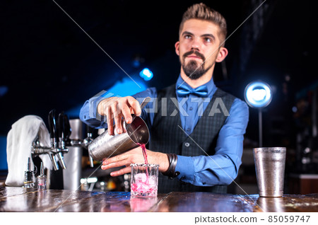 Bartender concocts a cocktail at the alehouse Bartender concocts a cocktail at the alehouse 85059747