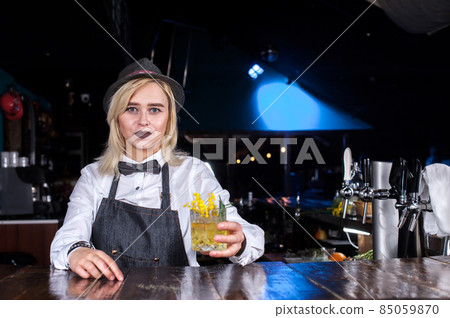 Girl bartender concocts a cocktail on the saloon Girl bartender concocts a cocktail on the saloon 85059870