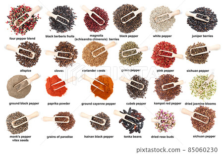 set of wood scoops in piles of various spices 85060230