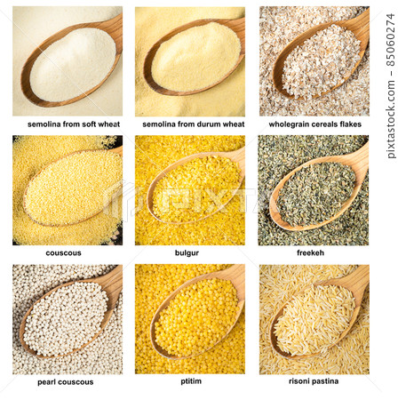 set of various wheat groats in wood spoons closeup 85060274