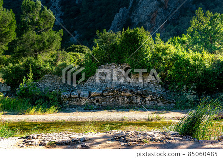 ruins of ancient buildings on the background of mountains in the antique city of Olympos, Turkey ruins of ancient buildings on the background of mountains in the antique city of Olympos, Turkey 85060485