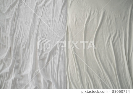 Crumpled used sheets on the bed. View from above. Crumpled used sheets on the bed. View from above. 85060754