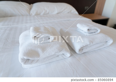 Stack towel set on bed in modern bedroom at hotel 85060894