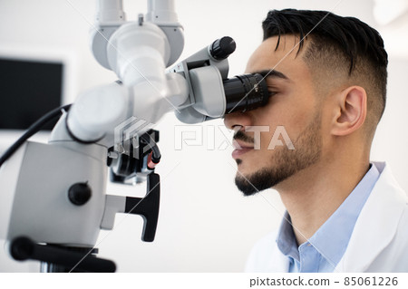 Closeup Shot Of Middle Eastern Medical Worker Using Dental Microscope In Clinic 85061226