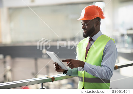 Smiling african american civil engineer with digital tablet, side view 85061494