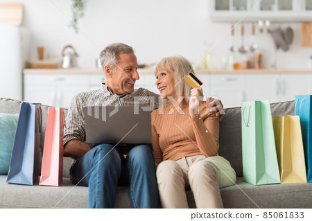 Senior Couple Shopping Online Using Laptop And Credit Card Indoor 85061833