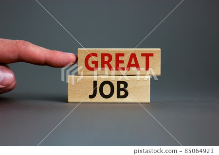 Great job. Wooden blocks with words 'great job' on beautiful grey background. Male hand. Business and great job concept, copy space. 85064921
