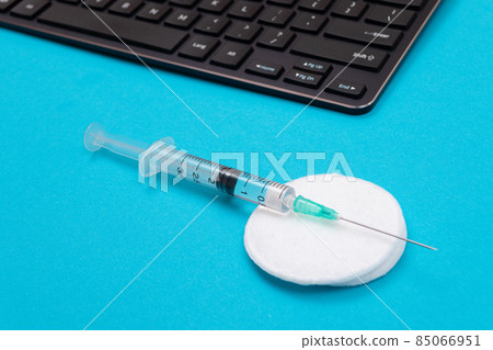 Vaccination or Revaccination Concept - A Medical Syringe on Blue Table 85066951
