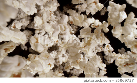 Macro shot of falling popcorn on black background Macro shot of falling popcorn on black background 85069737
