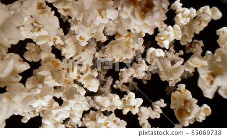 Macro shot of falling popcorn on black background 85069738