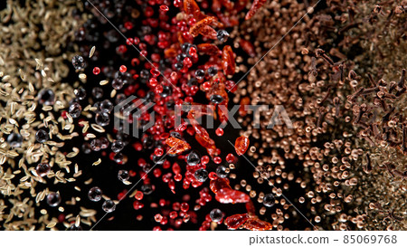 Freeze motion of flying mix of spice on black background. Freeze motion of flying mix of spice on black background. 85069768