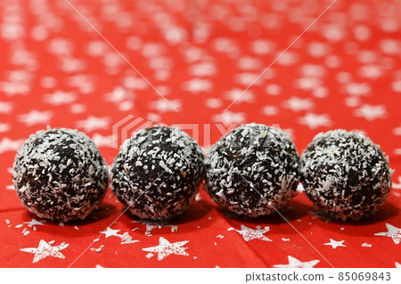 Christmas sweets. Rum balls wrapped in coconut. Traditional homemade handmade Christmas cookies in the Czech Republic. Christmas sweets. Rum balls wrapped in coconut. Traditional homemade handmade Christmas cookies in the Czech Republic. 85069843