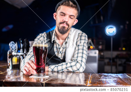 Young bartender demonstrates his professional skills Young bartender demonstrates his professional skills 85070231