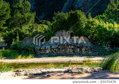 ruins of ancient buildings on the background of mountains in the antique city of Olympos, Turkey ruins of ancient buildings on the background of mountains in the antique city of Olympos, Turkey 85070476