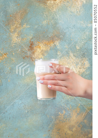 Woman hands holding coffee glass mug or cup Woman hands holding coffee glass mug or cup 85070552