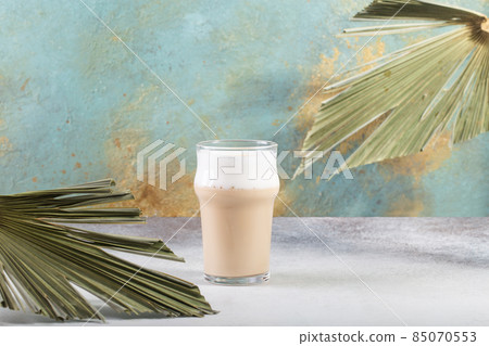 Cafe Latte On The Concrete Table palm tree leaves Cafe Latte On The Concrete Table palm tree leaves 85070553