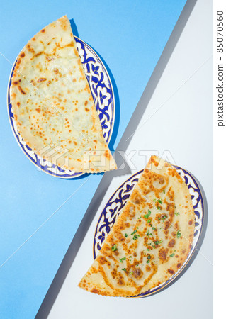Traditional azerbaijan cuisine flat bread with herbs kutaby qutabi kutabi on blue 85070560
