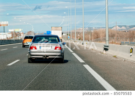 Vehicles driving on the highway in heavy traffic Vehicles driving on the highway in heavy traffic 85070583