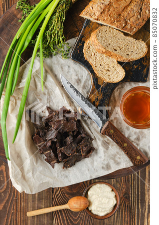 Top view of heap of jerky venison on wrapping paper 85070832