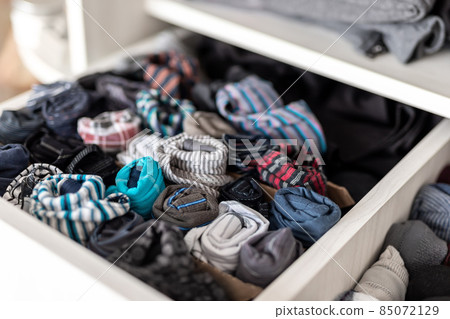 Home drawer box with organized folded underwear lingerie KonMari marie kondo vertical storage method. Sorted many different undergarments pants and socks at bedroom dresser 85072129