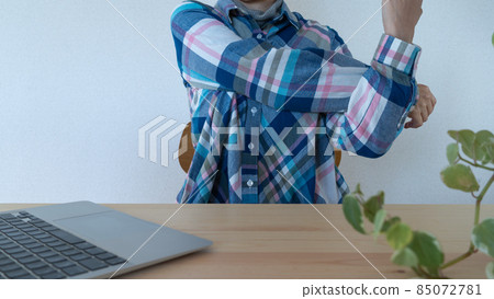 Image of a woman stretching her shoulders during work 85072781