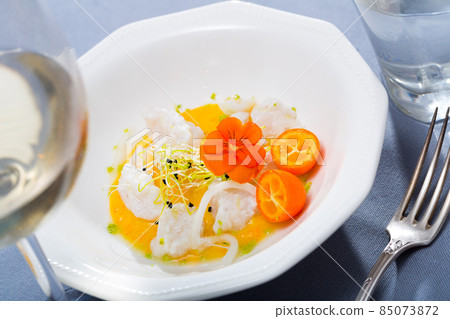 Seafood ceviche from horse-mackerel with spicy avocado sauce, greens and cumquat 85073872