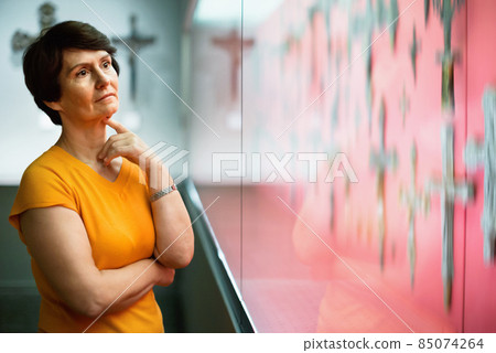 Portrait of elderly woman looking with interest exposition in mu Portrait of elderly woman looking with interest exposition in mu 85074264