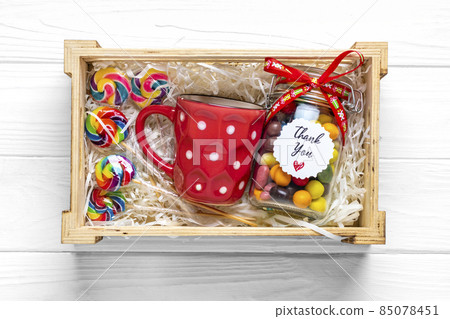Handmade care package, seasonal gift box with candies, cup on white table Personalized eco friendly basket for family, friends, girl for thanksgiving, xmas, Christmas, mothers, fathers day Flat lay 85078451