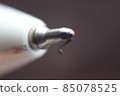 Macro photo of ballpoint pen tip with dark grey background. 85078525