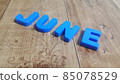 Plastic colored alphabets making words June are placed on a wooden floor 85078529