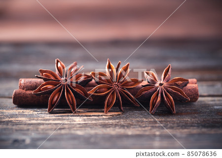 Star anise and cinnamon stick on wooden background Star anise and cinnamon stick on wooden background 85078636