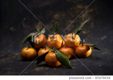 Bright orange Tangerines on black background 85079438