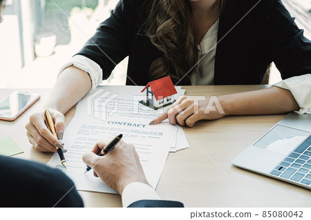Close up of Businesswoman and customer pointing and signing agreement for buying house. Bank manager concept. Close up of Businesswoman and customer pointing and signing agreement for buying house. Bank manager concept. 85080042