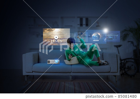 young male sitting on the sofa and watching a tv with OTT service young male sitting on the sofa and watching a tv with OTT service 85081480