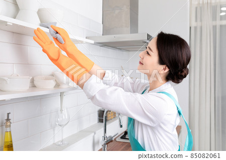 Asian woman wearing white shirt and apron, professional home cleaning service job 85082061