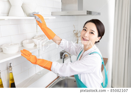 Asian woman wearing white shirt and apron, professional home cleaning service job 85082107