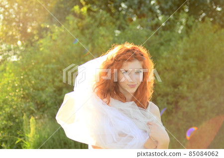 A young beautiful ore girl of the Caucasian appearance is having fun with pineapple. Place for text.Vegan, vegetarianism, healthy lifestyle, positive concept A young beautiful ore girl of the Caucasian appearance is having fun with pineapple. Place for text.Vegan, vegetarianism, healthy lifestyle, positive concept 85084062