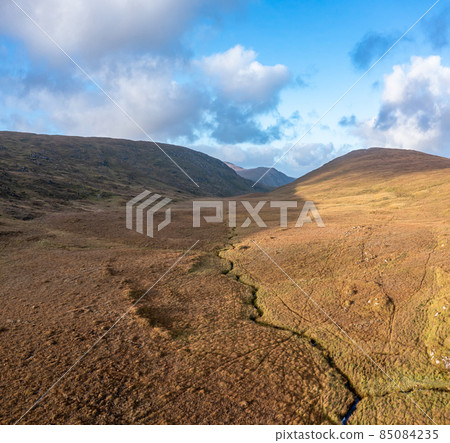 Beatiful stream flowing from the Mountains surrounding Glenveagh National Park - County Donegal, Ireland. Beatiful stream flowing from the Mountains surrounding Glenveagh National Park - County Donegal, Ireland. 85084235