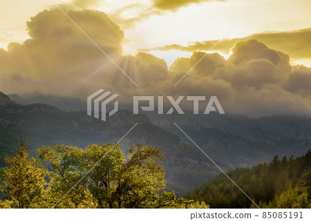 The first rays of sun because of clouds in mountains of Turkey 85085191