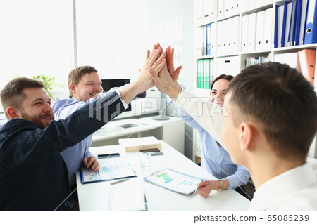 Witty colleagues performing high five gesture in order to celebrate important profitable project Witty colleagues performing high five gesture in order to celebrate important profitable project 85085239