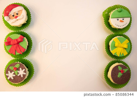 Christmas cupcakes, New Year's dessert. Santa claus cupcakes, snowman cupcakes. Dessert for new year and christmas Christmas cupcakes, New Year's dessert. Santa claus cupcakes, snowman cupcakes. Dessert for new year and christmas 85086344