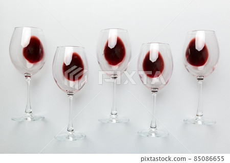 Many glasses of red wine at wine tasting. Concept of red wine on colored background. Top view, flat lay design Many glasses of red wine at wine tasting. Concept of red wine on colored background. Top view, flat lay design 85086655