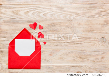 Red paper envelope with empty white card and heart on colored background. top view valentines day concept 85086790