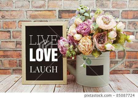 Live Love Laugh text on Blackboard and flower bouquet decoration wooden background 85087724