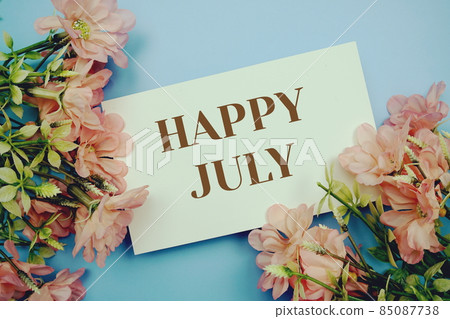 Happy Julytext with flower frame on blue background 85087738