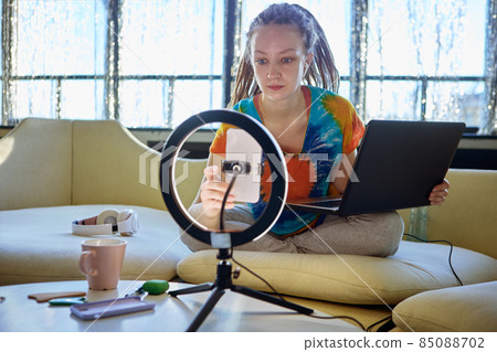 Ring light with phone holder, for woman vlogger working at home. 85088702