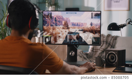 Male gamer playing tank videogame 85088705