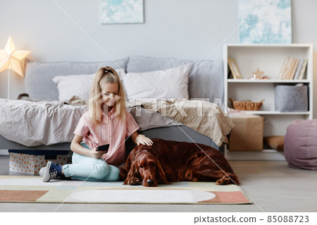 Girl with Dog at Home 85088723